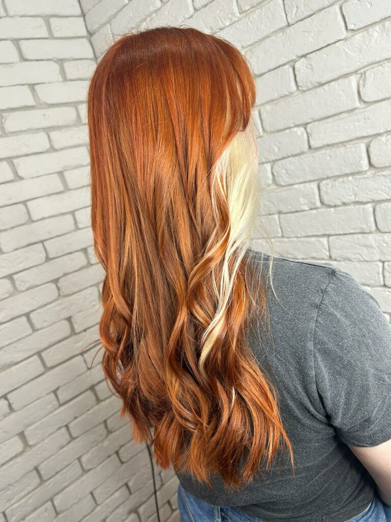 Red copper hair with a pop of blonde face framing