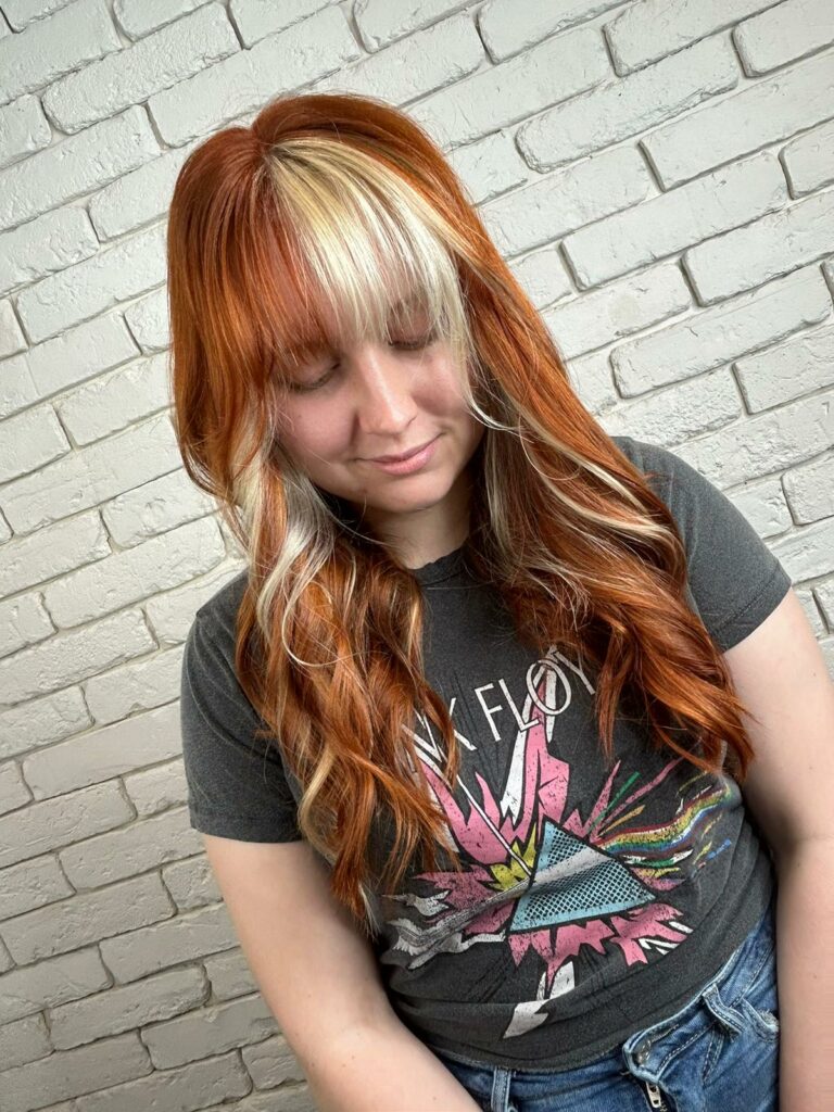 Red copper hair with a pop of blonde face framing